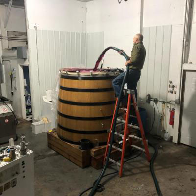 Filling massive red wine vat